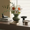 Floral Display With Green Vase White Orange Flowers Green Leaves And Books On Wooden Table