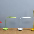Colorful Table Lamps with Red Green White Yellow Curved Pole Round Base on Wooden Table