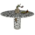 Round Marble Dining Table with Brown Vase Flowers and Green Fruit Plate on Wooden Base