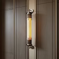 Contemporary Cylindrical Wall Light With Metal Frame And Warm Yellow Glow On Wooden Wall