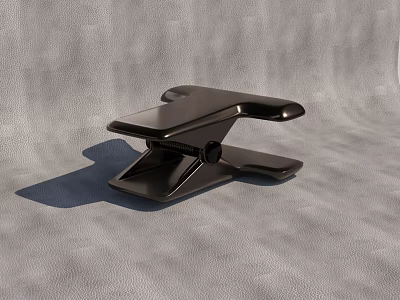 Modern Black Metal Clip With Ergonomic Grip On Textured Gray Surface 3d model