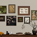 Framed Botanical Paintings as Wall Decor with Vase Oranges Candles and Books