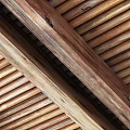 Natural Wooden Ceiling Design With Wooden Beams And Slatted Panels Showcasing Rustic Texture Details