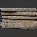 Neatly Stacked Bricks with Textured Surfaces on Dark Reflective Background