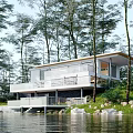 Modern Detached Villa With Glass Facade And Waterfront Location Among Trees
