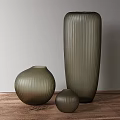 Ribbed Olive Green Glass Vases in Various Sizes on Wooden Table with Light Gray Wall