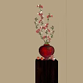 Red Vase with Red Flowers and Small Red Fruits on Dark Stand with Sunlight Shadows