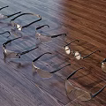 Different Types Of Safety Glasses Lined Up On Wooden Floor With Clear Lenses