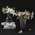 Transparent And Textured Vases With White Pink Lilies On Stack Of Books