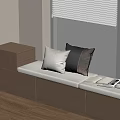 Modern Window Seat with White Black and Brown Pillows Open Book and Wooden Drawer Cabinet