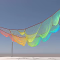 Colorful Wavy Net Art Installation Hanging Against Blue Sky With Support Pole