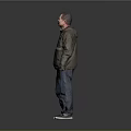 Man Standing Against Gray Background Wearing Green And Dark Green Jacket Blue Jeans And Sneakers