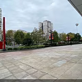 Vibrant Commercial Street With Modern Shops Paved Square Outdoor Seating And High Rise Buildings