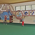 Kindergarten Indoor Play Area With Kids Playing On Climbing Net And Slide