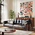 Black Leather Multi Person Sofa With Black White Patterned Pillows Abstract Painting And Green Plant