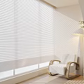 White Venetian Blinds Filtering Sunlight through Window in Modern Interior With Armchair