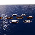 Multiple Traditional Wooden Boats Sailing On Calm Blue Sea With White Sails