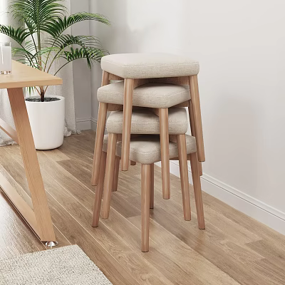 Stacked Stools With Beige Padded Seats And Wooden Legs On Light Wood Floor 3d model