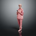 Woman In Pink Hoodie And Pants Holding Phone Against Gray Background With Black Floor Reflection