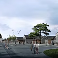 Scenic Ancient Architecture Complex With Street Pine Tree People Walking Under Cloudy Sky
