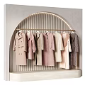 Stylish Winter Coats On Arch Display Rack With Soft Neutral Tones
