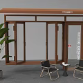 Glass Door Structure With Wooden Roof Featuring Two Black Chairs Small Round Table Green Plant