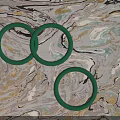 Three Elegant Green Rings Fashion Jewelry With Smooth Surface On Marble Background