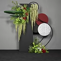 Floral Installation Featuring Black Pillar Greenery Red Blooms Hanging Vines And Red White Textured Circles