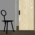 Black Dining Chair With Round Backrest Three Legs Near Light Wood Grain Door And White Wall
