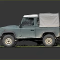 Vintage Teal Off Road Vehicle With Canvas Roof Parked On Grass Platform