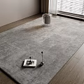 Square Gray Rug on Wooden Floor with Transparent Bin and Decorative Items