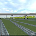 Railway Tracks With Overhead Bridge Structure And Green Grass Field Under Clear Sky