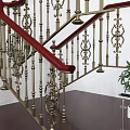 Elegant Staircase With Red Handrails Ornate Golden Balusters Dark Wooden Steps And Potted Green Plant