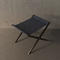 Modern Stool With Black Fabric Seat And Wooden Cross Legs In Minimalist Interior