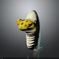 Cartoon Creature Toy Featuring Yellow Head Red Spots Open Mouth White Teeth And Turquoise Body