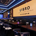 Bar Interior Design With Wine Shelves Various Bottles Bar Counter Chairs And Blue Lighting