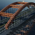 Orange Steel Frame Arch Bridge Over Water With Cars And Street Lights