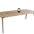 Wooden Dining Table With Slatted Top and Slim Legs Featuring Black Lantern Decoration