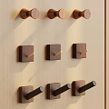 Wooden Hooks In Various Shapes Neatly Arranged On Light Wooden Wall