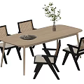 Modern Wooden Dining Table Set with Rattan Back Chairs Vase Greenery and Decorative Plate