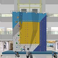Indoor Rock Climbing Wall With Vibrant Blue Yellow Sections And Climbing Holds In Shopping Mall