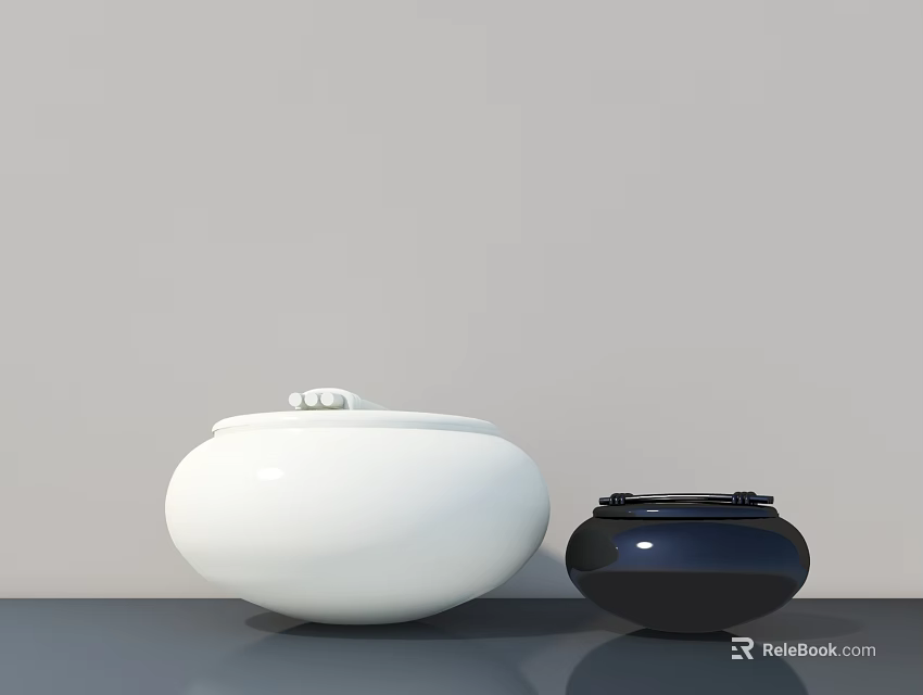White And Black Ceramic Decorative Ornament Set With Round Shaped Design On Gray Tabletop 3d model 