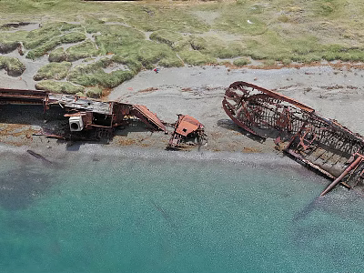 Aerial View Coastal Scenery Featuring Shipwreck Remains Sandy Beach Green Grass And Clear Blue Water 3d model