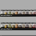 Neatly Arranged Glass Spice Jars with Labels on Black Kitchen Shelves