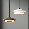 Modern Layered Pendant Lights In Black And White Hanging On Gray Wall