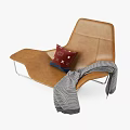 Brown Leather Leisure Chair with Red Cushion and Gray Plaid Blanket on Metal Legs