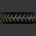 Large Industrial Tire With Deep Tread And Worn Metallic Rim On Dark Background