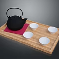 Black Cast Iron Teapot with Red Mat on Wooden Tray and Four White Small Bowls