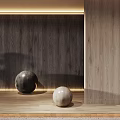 Two Decorative Spheres On Wooden Floor With Textured Wall And Warm Lighting