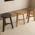 Three Different Colored Stools Black Light And Dark Wooden On Carpeted Floor In Room
